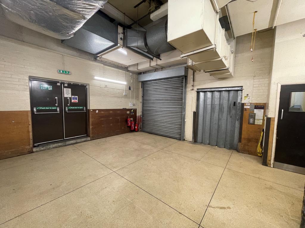 Lot: 145 - VACANT COMMERCIAL PREMISES IN HIGH STREET LOCATION - Rear of ground floor with roller door and lift